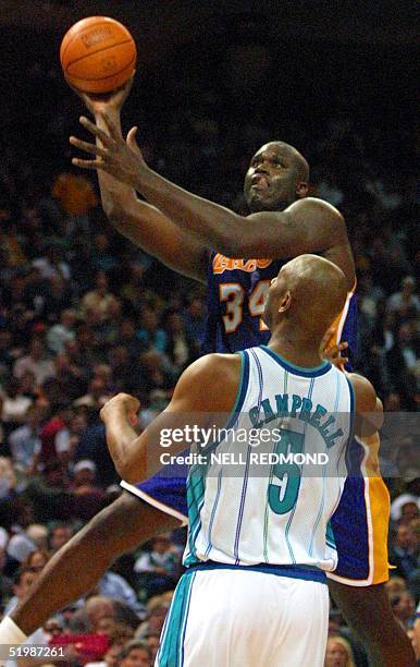 Los Angeles Lakers center Shaquille O'Neal scores two of his 31 points over Charlotte Hornets Elden Campbell in the second half at the Charlotte...