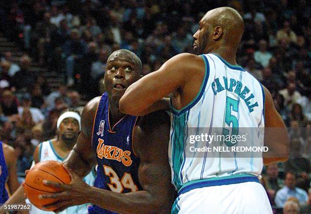 Los Angeles Lakers Center Shaquille O'Neal drives to the basket around Charlotte Hornets center Elden Campbell in the second half at the Charlotte...