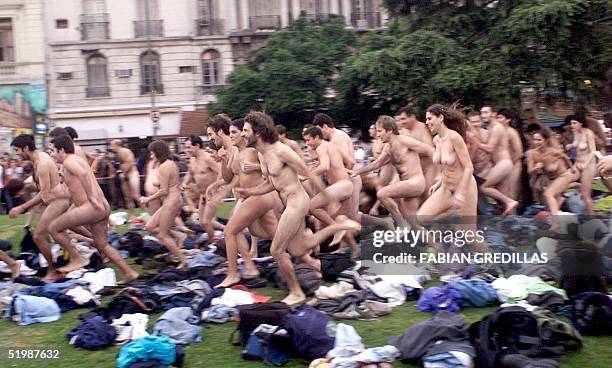 Group of naked people are seen running to pose for photographer Spencer Tunick, in central Buenos Aires, 06 April 2002. New York photographer Spencer...