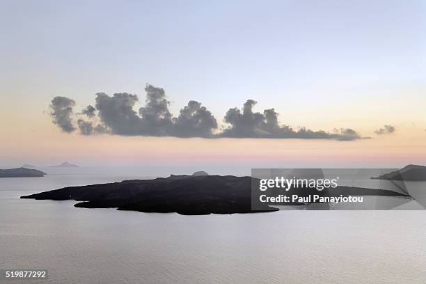 volcanic islet of nea kameni seen from fira town - santorini volcano stock pictures, royalty-free photos & images