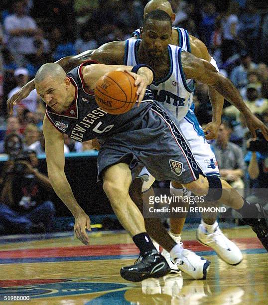 New Jersey Nets' guard Jason Kidd keeps his balance as he drives past Charlotte Hornets' forward George Lynch in the second half of game four in the...