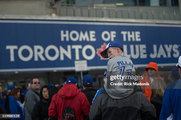 Liam Dunlop of Guelph, sits atop his dad's shoulders as they wait in line to gender at Gate 5. Toronto Blue Jays fans get to the Rogers Centre early...