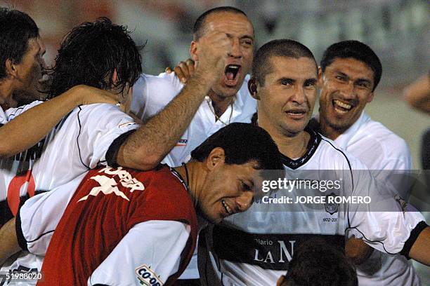 Soccer players celebreae their victory in Asuncion, Paraguay 16 May 2002. Jugadores del Olimpia de Paraguay celebran la victoria ante Boca y su pase...