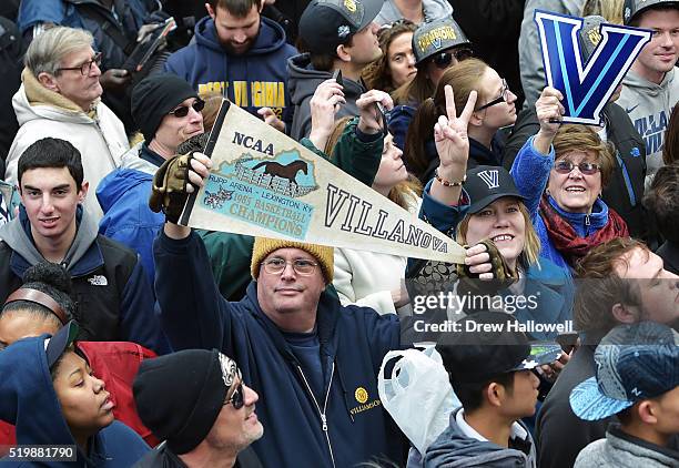 Fan holds a tenant from the last championship in 1985 during the Villanova Wildcats Championship Parade on April 8, 2016 in Philadelphia,...