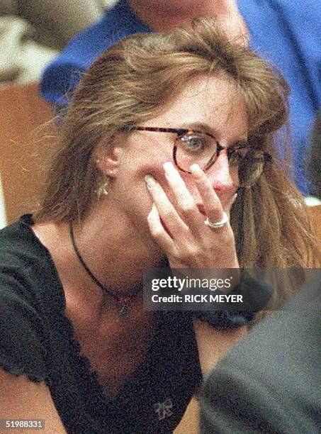 Kim Goldman, sister of murder victim Ron Goldman, watches as a picture of her brother's bloody shirt is displayed in court during direct examination...