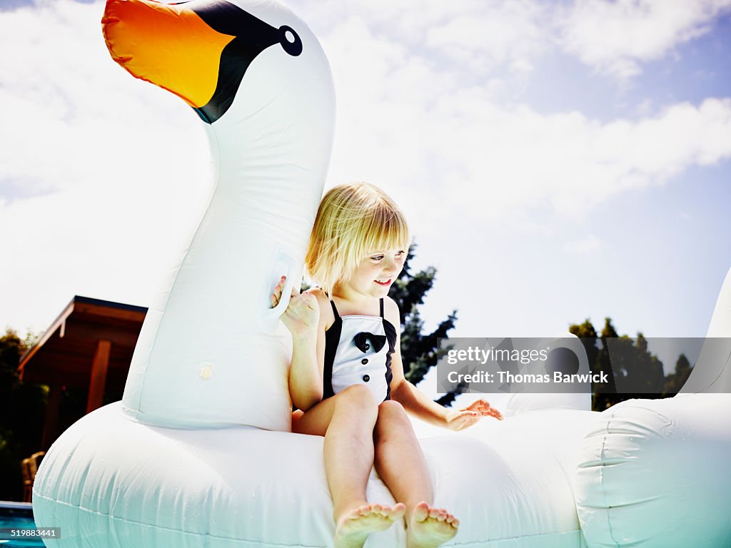 Young Inflatable Smiling Young Girl Floating On Inflatable Pool Toy High-Res Stock Photo ...