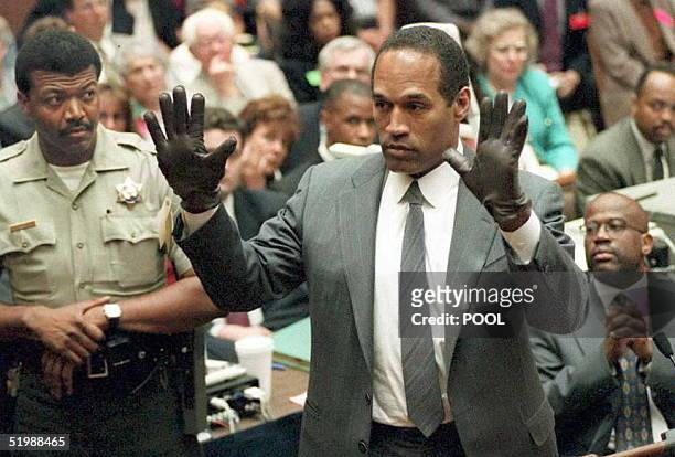 Simpson shows the jury a new pair of Aris extra-large gloves, similar to the gloves found at the Bundy and Rockingham crime scene 21 June during his...