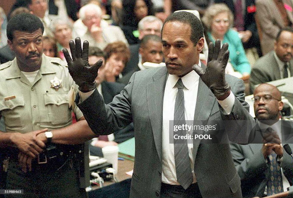 O.J. Simpson shows the jury a new pair of Aris ext