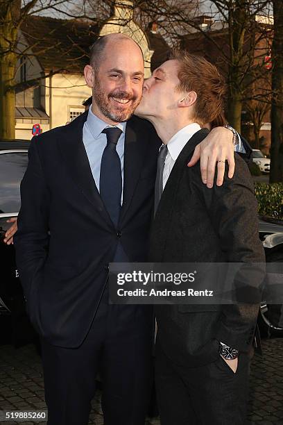 Jonas Nay kisses Edward Berger upon their arrival at the 52th Grimme Award on April 8, 2016 in Marl, Germany.