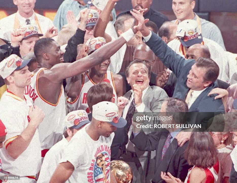 Houston Rockets' Hakeem Olajuwon(L) gets a high fi