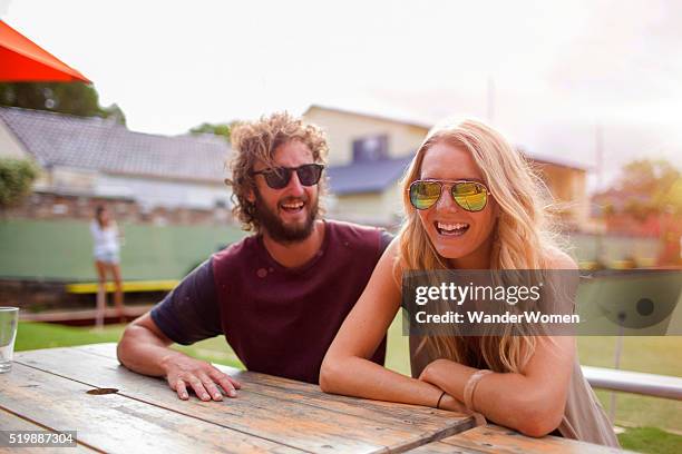 couple at table laughing at lawn bowls club australia - blind date stock pictures, royalty-free photos & images