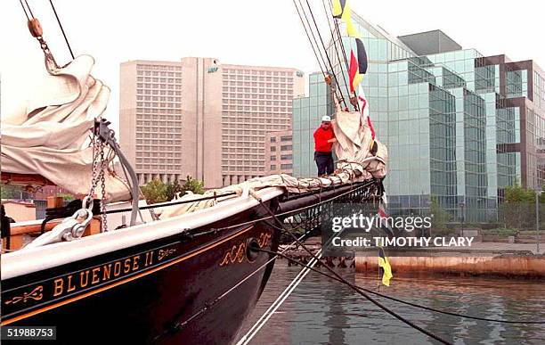 Worker hangs flags on the schooner Bluenose II 13 June in Halifax Harbour as preparations continue for the opening of the G7 Summit. Summit Place,...