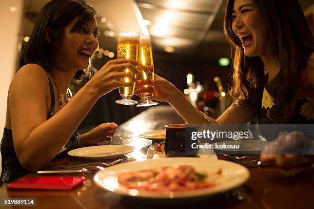 women to toast a beer in the tavern - beer luxury stock pictures, royalty-free photos & images