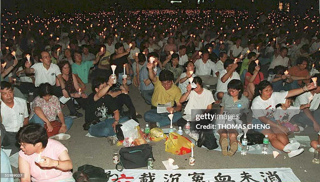People sit during a candlelight vigil in Victoria