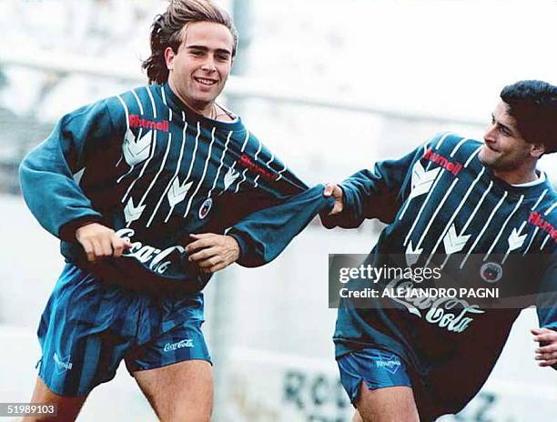 Chilean soccer player Sebastian Rosental has his jersey pulled by teammate Ronald Fuentes as Chile's Copa America team works out 05 July in Paysandu,...