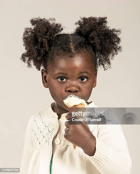 adorable little girl eating an ice cream cone - girls licking girls stock pictures, royalty-free photos & images