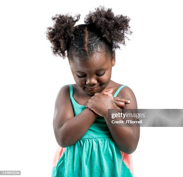 adorable little girl looking down - hand on heart stock pictures, royalty-free photos & images