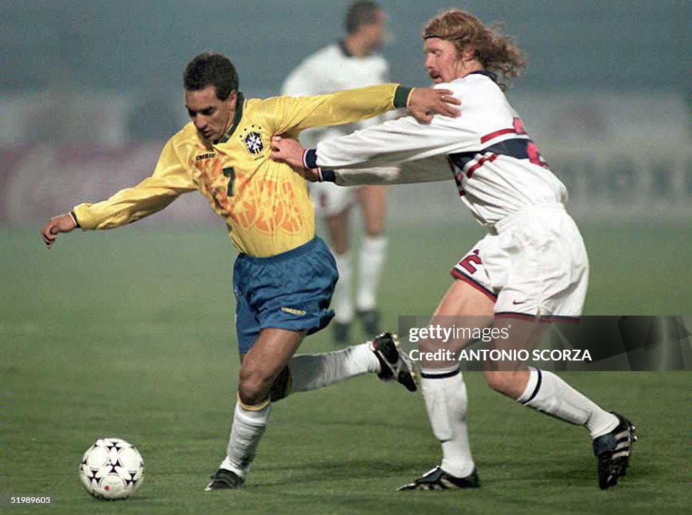 Alexi Lalas (R) of the US soccer team pushes Brazi