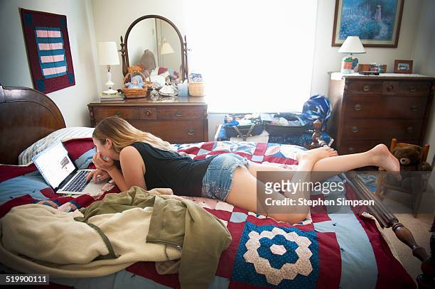 teen girl on laptop in her grandmother's bedroom - 13 year old girls in shorts stock pictures, royalty-free photos & images