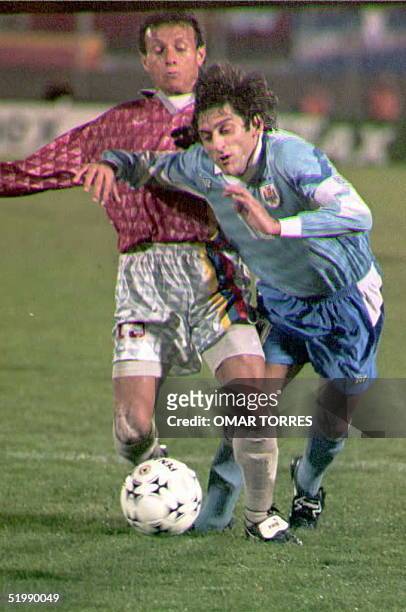Venezuelan player Alexander Hezel battles Uruguayan player Enzo Francescoli 05 July during a Group A match at the 1995 Copa America in Montevideo,...