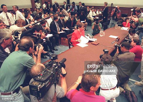 Attorney General Janet Reno is surrounded by photographers before testifying to a congressional subcommittee in Washington on the final day of two...