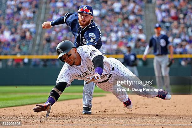 Carlos Gonzalez of the Colorado Rockies is tagged out by second baseman Cory Spangenberg of the San Diego Padres for a double play after getting...