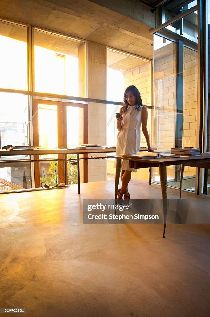 Businesswoman on phone in architectural office