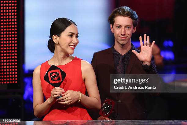 Max Mauff and Aisawanya Areyawattana smile as they receive their awards at the 52th Grimme Award on April 8, 2016 in Marl, Germany.