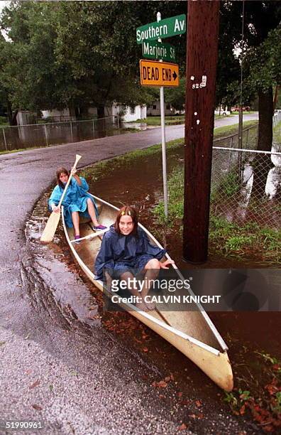 Teresa Bell, 14-years-old, and her buddy Amber Berger, 13-years-old, navigate a turn in the road as they paddle a canoe throught a drainage ditch...