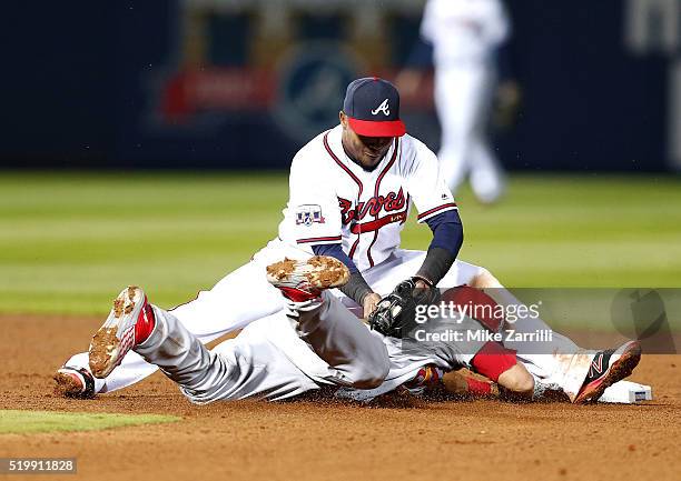 Third baseman Matt Carpenter of the St. Louis Cardinals tries to stretch a single to a double and is tagged out by shortstop Erick Aybar of the...