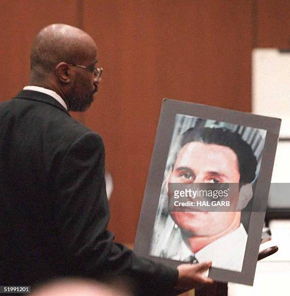 Prosecutor Christopher Darden holds up a photograph of murder victum Ronald Goldman while he addresses the jury during closing arguments 27 September...