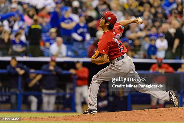 Koji Uehara of the Boston Red Sox throws a pitch during the MLB spring training game against the Toronto Blue Jays at Olympic Stadium on April 2,...