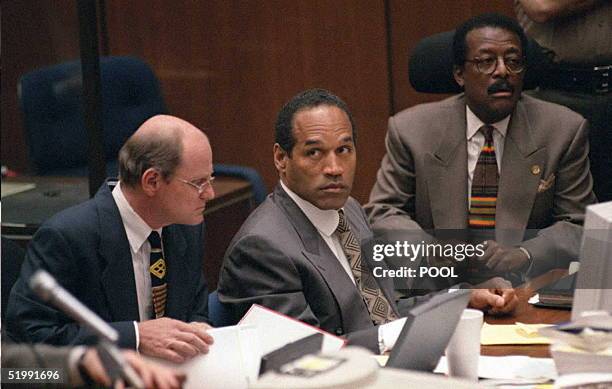 Double murder defendant O.J. Simpson sits with his attorneys Johnnie Cochran Jr and Robert Blasier during a court hearing in the O.J. Simpson murder...