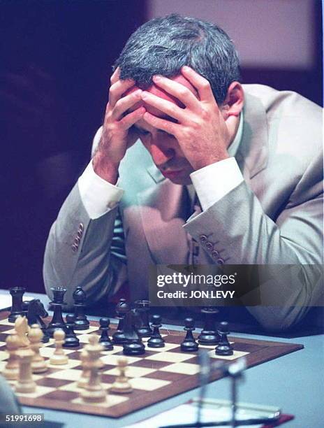 World Chess Champion Gary Kasparov from Russia holds his head in his hands as he contemplates a move in the World Chess Championship match against...