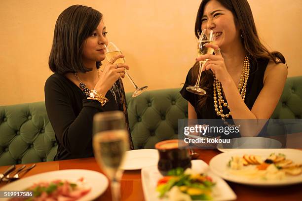 women taste the champagne in the restaurant - drunk asian women stock pictures, royalty-free photos & images