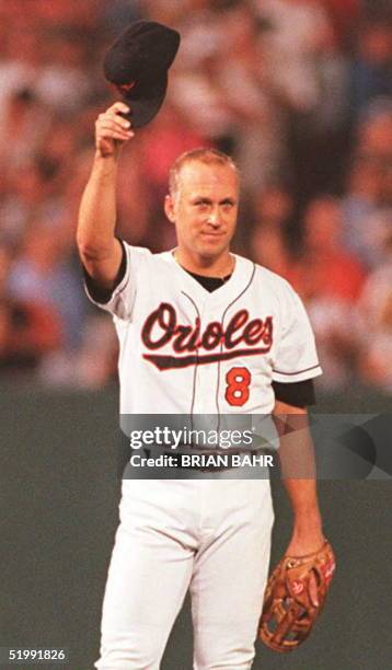 Cal Ripken Jr. Of the Baltimore Orioles tips his hat to the crowd as he takes his position on the field at the start of the 06 September game against...