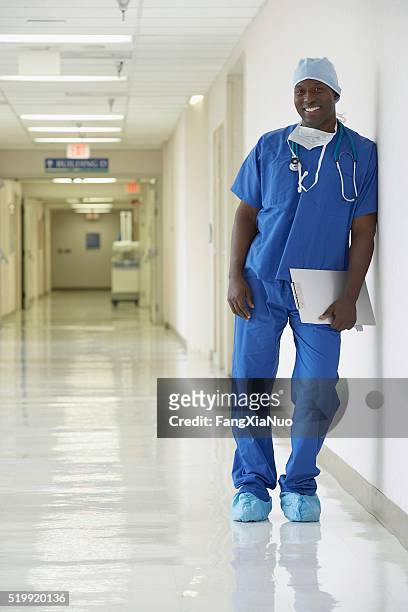 nurse standing in a hospital corridor - nurse standing stock pictures, royalty-free photos & images
