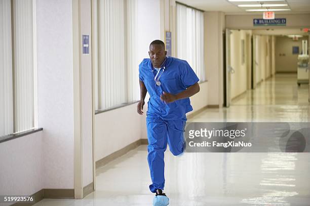 nurse running through a hospital corridor - doctor emergency stock pictures, royalty-free photos & images