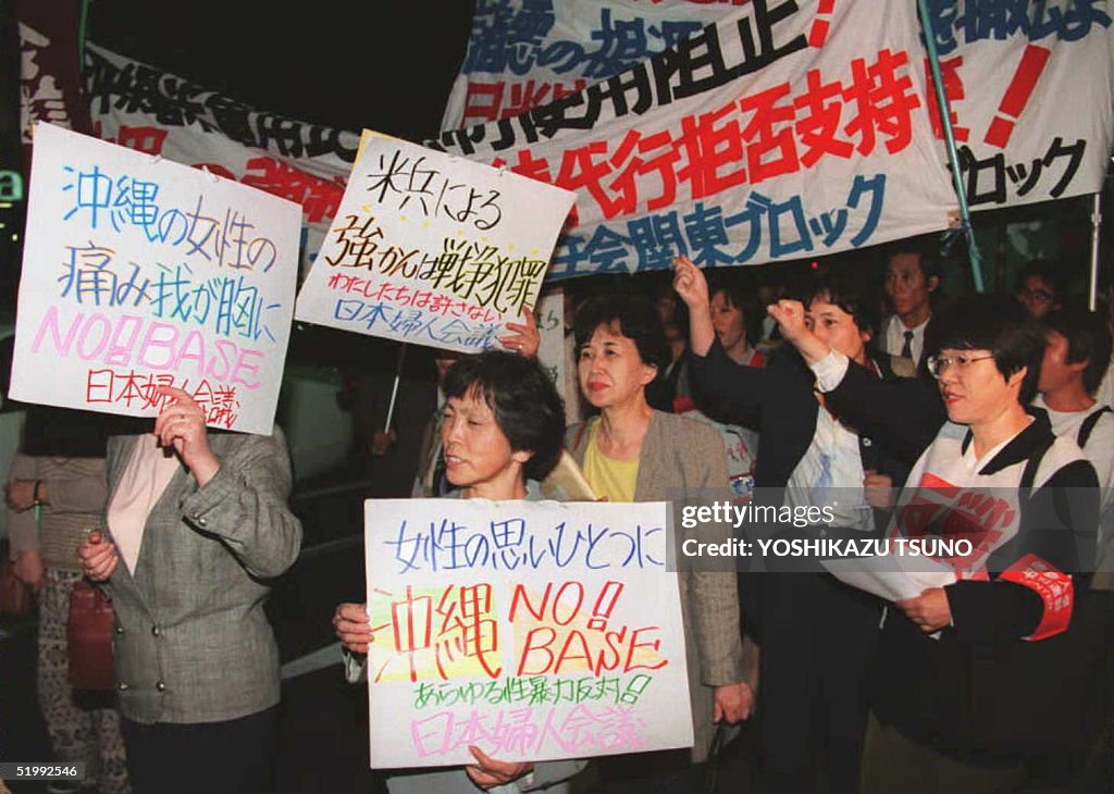 Female civil group members, holding banners protes