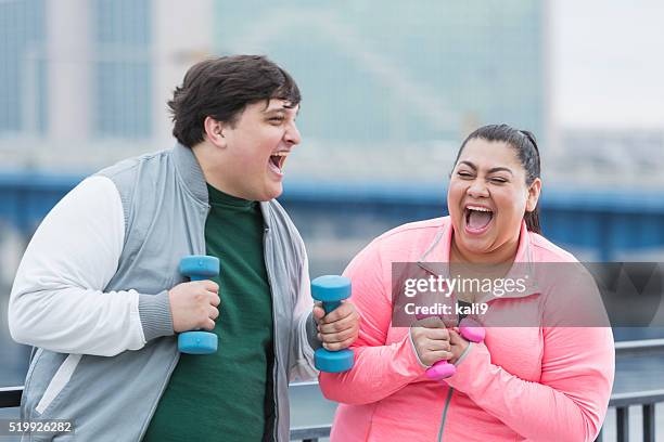 overweight hispanic man and woman exercising, laughing - fat woman funny stockfoto's en -beelden