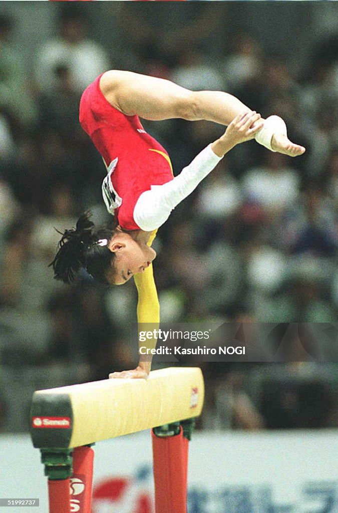 Mo Huilan of China competes on the balance to take the gold in the