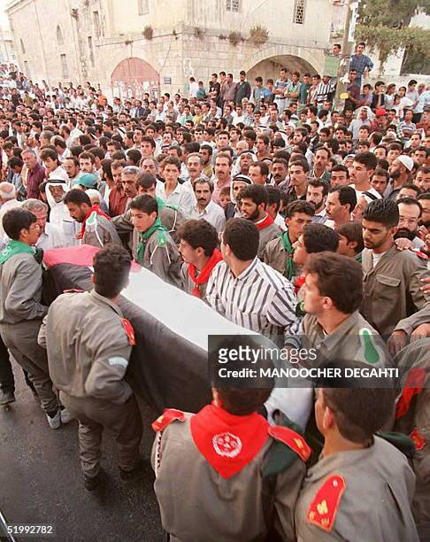 Palestinians carry the coffin of Abdelrazek Shakra 09 October during his funeral in Ramallah. Shakra, a 23-year-old Palestinian prisoner, was found...