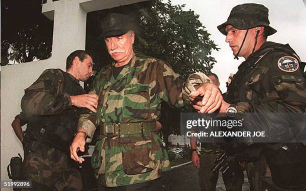 French veteran mercenary Bob Denard surrenders to French troops 05 October outside the army base in the Comoros. The French special forces arrested...