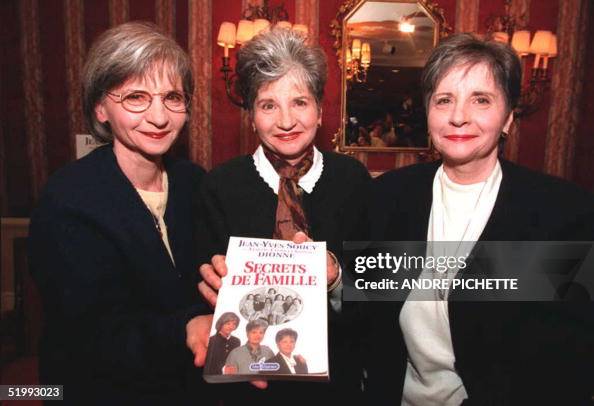 Yvonne (L), Audette (C) and Cecil (R) Dionne hold Yvonne (L), Audette (C) and Cecil (R) Dionne hold