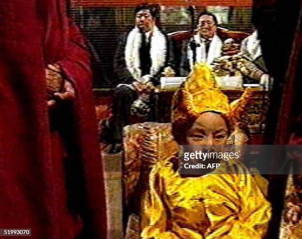 Television grab shows the 11th Panchen Lama, which was approved by the Chinese government as Tibet's second most important spiritual leader, wearing...