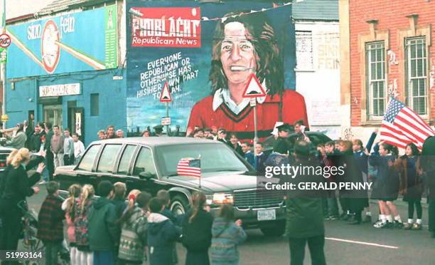 President Bill Clinton's car passes the Sinn Fein headquarters in Falls Road in Belfast with a mural of hungerstriker Bobby Sands in the background...