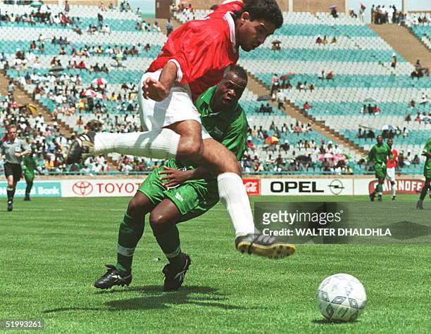 Egyptian Hazem Emam leaps for a kick and snatches the ball from a Zambian mid-fielder, during Four Nations Cup finals in Johannesburg 26 November....