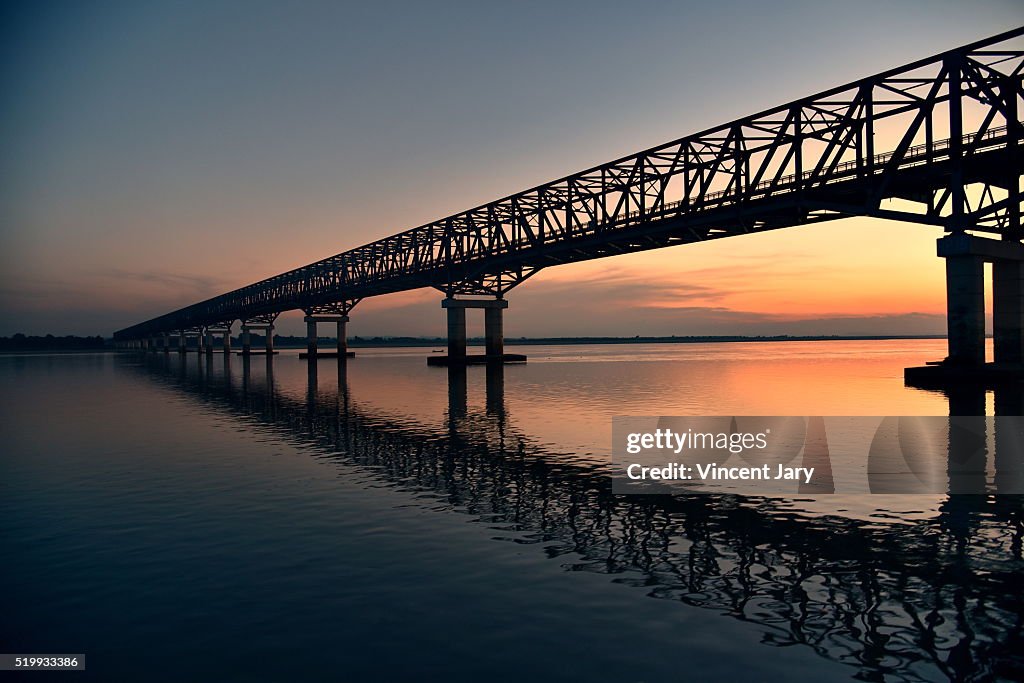 Irrawaddy river bridge at sunset with reflection sky Myanmar Asia