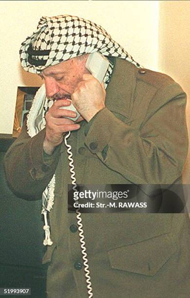 Palestinian leader Yasser Arafat talks to the wife of former Israeli Prime Minister, Yitzhak Rabin, from his office in Gaza City late on 4th November...