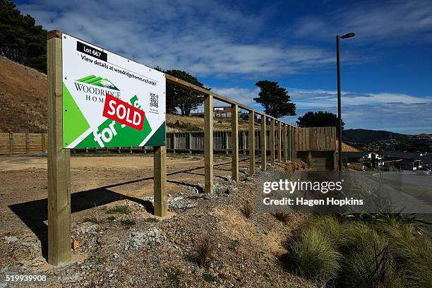 Sold' sign is seen on an empty lot in the suburb of Woodridge on April 9, 2016 in Wellington, New Zealand. Increased demand for property in...